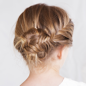 the back of a little girls head, blond hair with beautiful braid in a bun